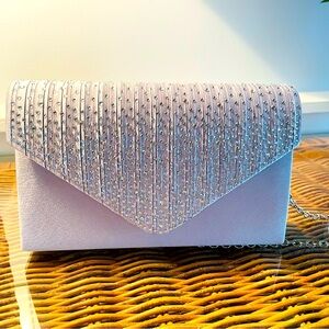 Small formal clutch with detachable strap